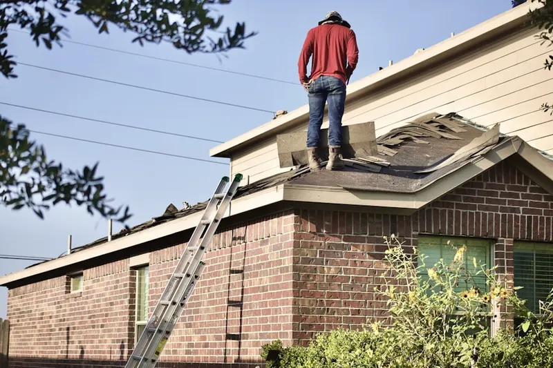 Professional roofer working on a residential roof in Meadows Terrace